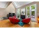 Spacious living room with fireplace, large windows, skylight, hardwood floors and vibrant modern furniture at 81502 Alexander, Chapel Hill, NC 27517