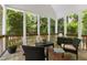 Relaxing screened porch with wooded views, wicker chairs, and sunlight at 81502 Alexander, Chapel Hill, NC 27517