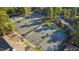 Aerial view of multiple well-maintained tennis courts with green surfaces, surrounded by mature trees and landscaping at 81502 Alexander, Chapel Hill, NC 27517