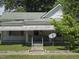 Charming home featuring a welcoming front porch, complemented by verdant landscaping and a well-maintained lawn at 824 Beal St, Rocky Mount, NC 27804