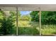 View from the covered porch overlooking a lush, green backyard at 995 Shawtown Rd, Lillington, NC 27546