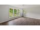 This bedroom features natural light with three large windows and wood flooring at 995 Shawtown Rd, Lillington, NC 27546