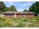 Charming one-story brick home with a classic design and ample natural light through the front windows at 995 Shawtown Rd, Lillington, NC 27546