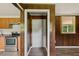 This hallway connects to the kitchen and is decorated with wood paneling at 995 Shawtown Rd, Lillington, NC 27546