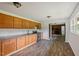 Spacious kitchen featuring wood cabinets, modern appliances, and a large window that offers natural light at 995 Shawtown Rd, Lillington, NC 27546