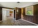 A spacious living room featuring hardwood floors, wood-paneled walls, and an open layout, perfect for entertaining at 995 Shawtown Rd, Lillington, NC 27546