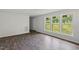 A bright living room featuring hardwood floors, white walls, and large windows, offering a spacious and inviting area at 995 Shawtown Rd, Lillington, NC 27546