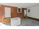 Covered patio with brick accents, offering access to entry doors and additional outdoor storage at 995 Shawtown Rd, Lillington, NC 27546