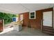 View of the covered patio with brick accent walls, providing ample outdoor space and storage at 995 Shawtown Rd, Lillington, NC 27546
