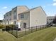 Rear view of a townhome featuring a fenced yard with a patio and sliding glass door at 100 Stratford Lakes Dr # 361, Durham, NC 27713