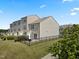 Backyard view, showing lawn, privacy fence, and the exterior of townhome at 100 Stratford Lakes Dr # 361, Durham, NC 27713