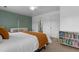 Cozy bedroom with bright-colored decor, featuring a crib and built in shelving unit at 100 Stratford Lakes Dr # 361, Durham, NC 27713