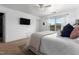 Bedroom featuring a ceiling fan, a large window, a TV mounted on the wall, and ample natural light at 100 Stratford Lakes Dr # 361, Durham, NC 27713