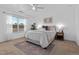 Inviting bedroom with large windows, a ceiling fan, neutral decor, and a decorative area rug at 100 Stratford Lakes Dr # 361, Durham, NC 27713