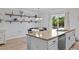 Dining area with modern lighting, open shelving, and a view of the kitchen counter at 100 Stratford Lakes Dr # 361, Durham, NC 27713