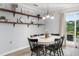 Cozy dining area with a round table set for six, with sliding glass doors to a patio at 100 Stratford Lakes Dr # 361, Durham, NC 27713