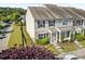 Exterior view of townhome with a well-maintained lawn and landscaping at 100 Stratford Lakes Dr # 361, Durham, NC 27713