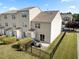 Rear aerial view of townhomes featuring a lawn, privacy fence, and well-kept landscaping at 100 Stratford Lakes Dr # 361, Durham, NC 27713
