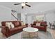 Spacious living room with hardwood floors, leather sofas, and a view of the staircase at 100 Stratford Lakes Dr # 361, Durham, NC 27713