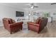 Bright living room showcasing cozy seating, a ceiling fan, and seamless access to the dining and kitchen areas at 100 Stratford Lakes Dr # 361, Durham, NC 27713