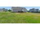Lush backyard with a well-maintained lawn, wooden deck, and ample space for recreation at 104 Jj Dr, Benson, NC 27504