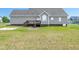 Spacious backyard with a wooden deck and lush green grass, perfect for outdoor activities at 104 Jj Dr, Benson, NC 27504