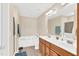 Bright bathroom with double sink vanity, tub, and shower at 104 Jj Dr, Benson, NC 27504