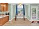 Inviting dining area with large windows, neutral walls, and a wooden dining table at 104 Jj Dr, Benson, NC 27504