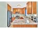 Well-lit kitchen features stainless steel appliances, light wood cabinets, and granite countertops at 104 Jj Dr, Benson, NC 27504