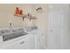 Functional laundry room with a washer, dryer, shelving, and a utility closet at 104 Jj Dr, Benson, NC 27504