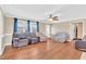 Spacious living room with hardwood floors, ceiling fan, and large windows at 104 Jj Dr, Benson, NC 27504