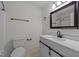 Clean bathroom featuring a modern vanity, toilet, framed mirror and shower-tub combination at 109 Virginia Pl, Cary, NC 27513