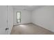 Carpeted bedroom with natural light from window and a convenient closet for storage at 109 Virginia Pl, Cary, NC 27513
