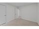 Cozy bedroom with neutral carpet, white walls, and a closet with an open door at 109 Virginia Pl, Cary, NC 27513
