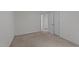 Neutrally decorated bedroom with beige carpet and a closet with mirrored doors at 109 Virginia Pl, Cary, NC 27513