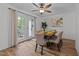 Cozy dining area features a ceiling fan and french doors that lead to an outdoor deck at 109 Virginia Pl, Cary, NC 27513