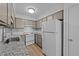 Functional kitchen featuring white appliances and neutral cabinetry, creating a clean and efficient cooking space at 109 Virginia Pl, Cary, NC 27513