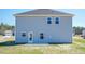 View of the backyard featuring a newly built home and a grassy yard at 111 High Hampton Way, Fuquay Varina, NC 27526