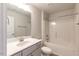 A bathroom featuring a shower-tub combo, a white vanity, and a modern faucet at 111 High Hampton Way, Fuquay Varina, NC 27526