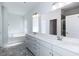 Bathroom features double sinks, modern vanity, soaking tub, and luxury finishes at 111 High Hampton Way, Fuquay Varina, NC 27526