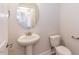 Small bathroom featuring a pedestal sink, a toilet, and an oval mirror at 111 High Hampton Way, Fuquay Varina, NC 27526