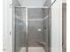 Bathroom features tiled walk-in shower with glass door, built in bench and neutral colors at 111 High Hampton Way, Fuquay Varina, NC 27526