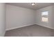 Empty bedroom with neutral walls, carpet, and a window providing natural light at 111 High Hampton Way, Fuquay Varina, NC 27526