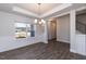Dining area with hardwood floors, wainscoting and modern light fixture at 111 High Hampton Way, Fuquay Varina, NC 27526