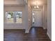 Bright living room featuring hardwood floors, large windows, and neutral paint at 111 High Hampton Way, Fuquay Varina, NC 27526