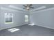 Bright main bedroom features new carpet, tray ceiling, fan, and plenty of natural light at 111 High Hampton Way, Fuquay Varina, NC 27526