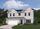Charming two-story home with a two-car garage, manicured lawn, and classic architectural details at 11121 Salers Loop, Middlesex, NC 27557