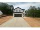 Two story home with light siding, a dark roof, open garage, and concrete driveway at 11147 Salers Loop, Middlesex, NC 27557