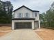 Two story home with light siding, a dark roof, open garage, and concrete driveway at 11147 Salers Loop, Middlesex, NC 27557