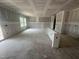 Interior view of a new construction room with sliding glass door, many windows, and breakfast bar at 11147 Salers Loop, Middlesex, NC 27557